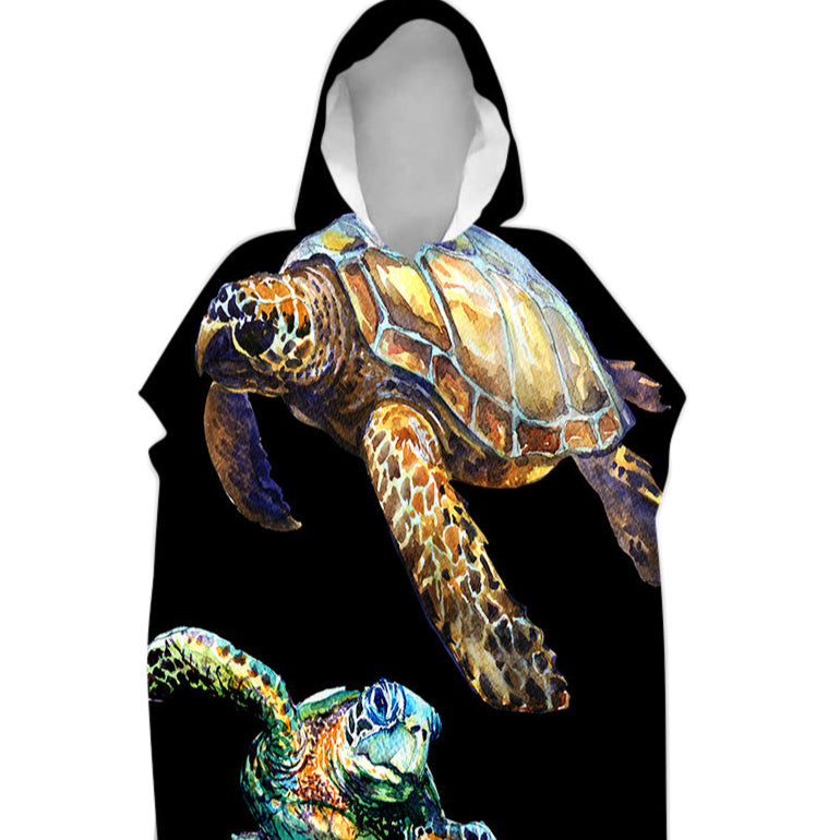 Hooded towel with turtle design on a black background